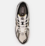 Zapatillas New Balance 1906R metallic silver/gold